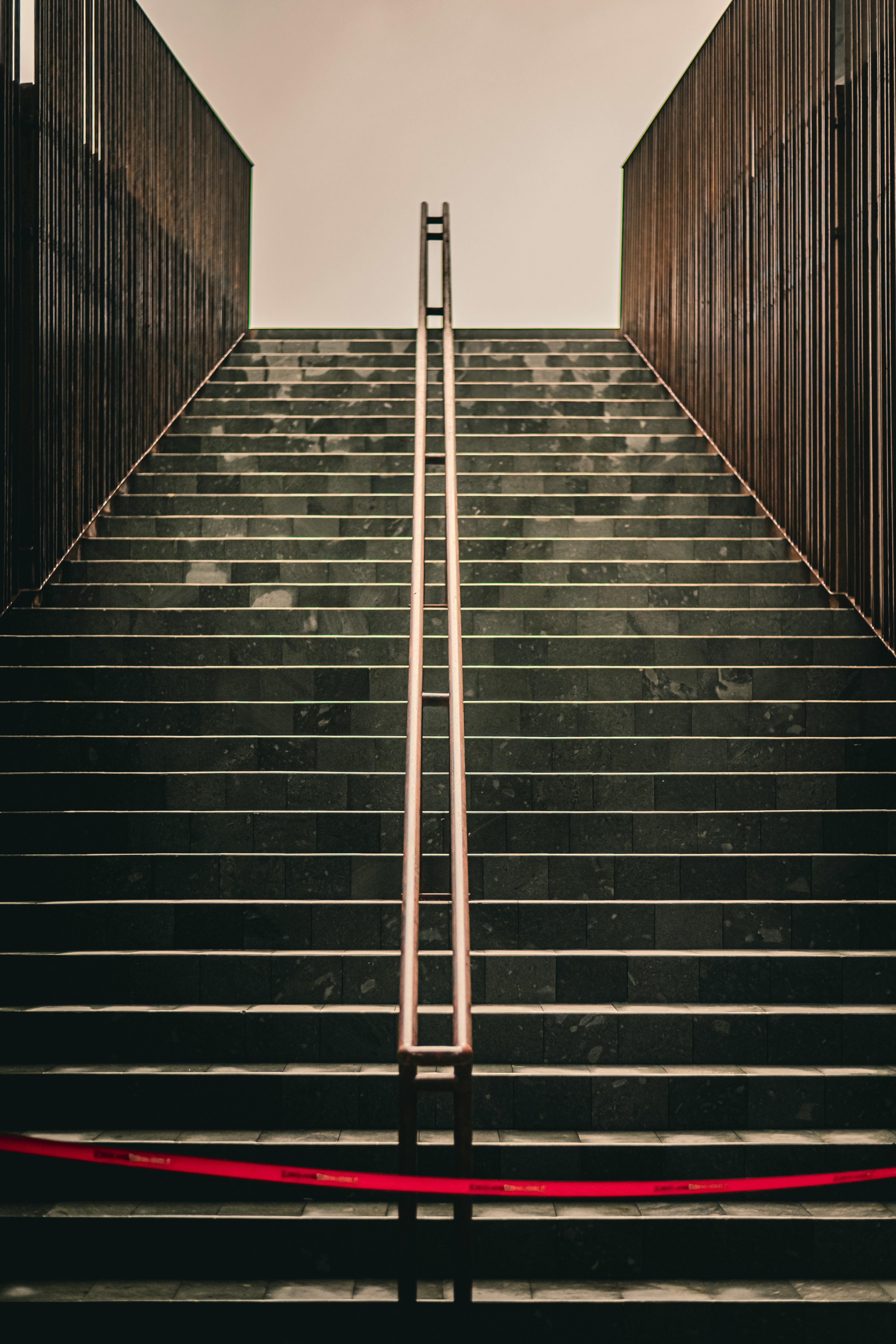 Monumental staircase with repeating stone arches and balustrades