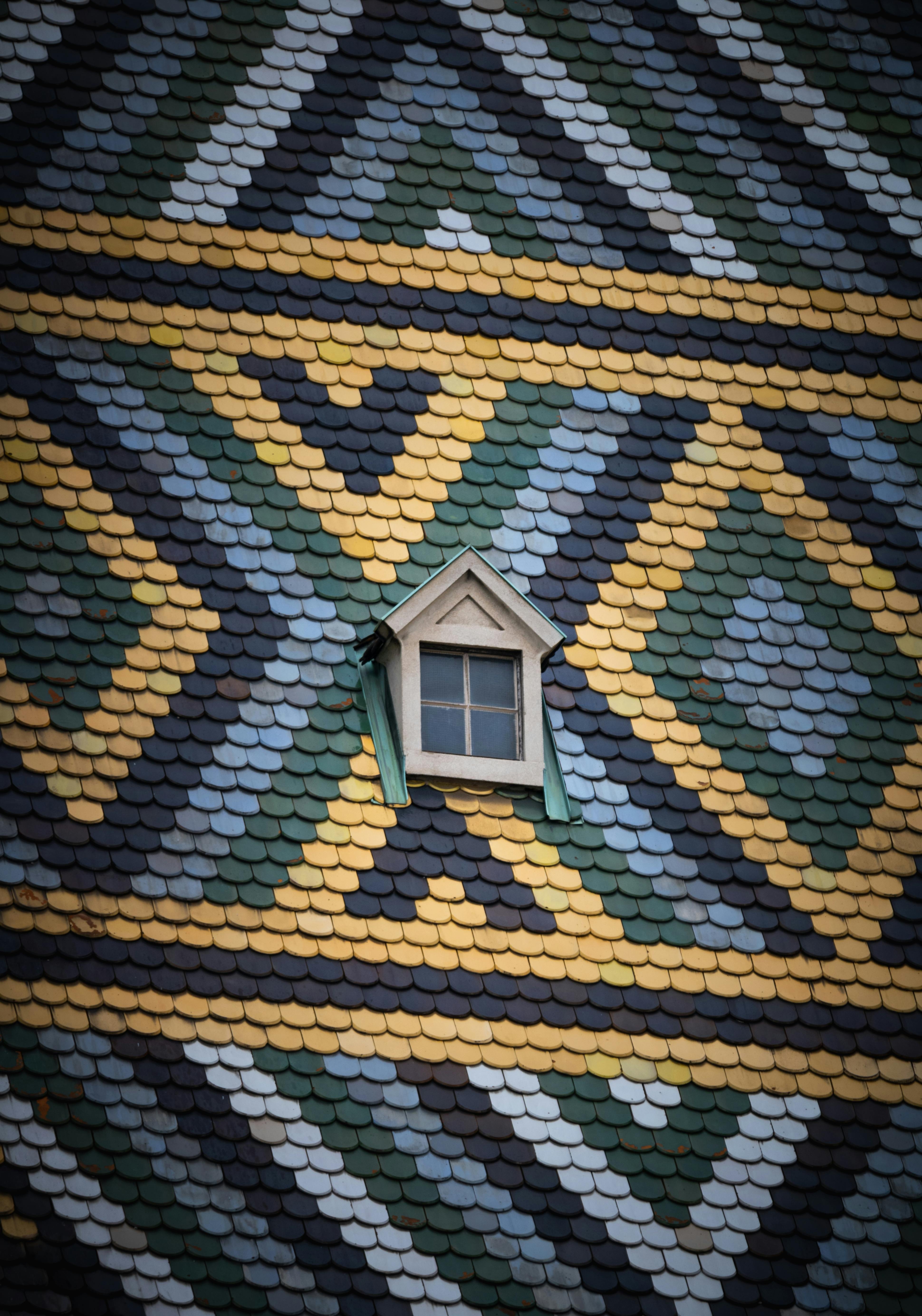 Patterned roof tiles with a small dormer window
