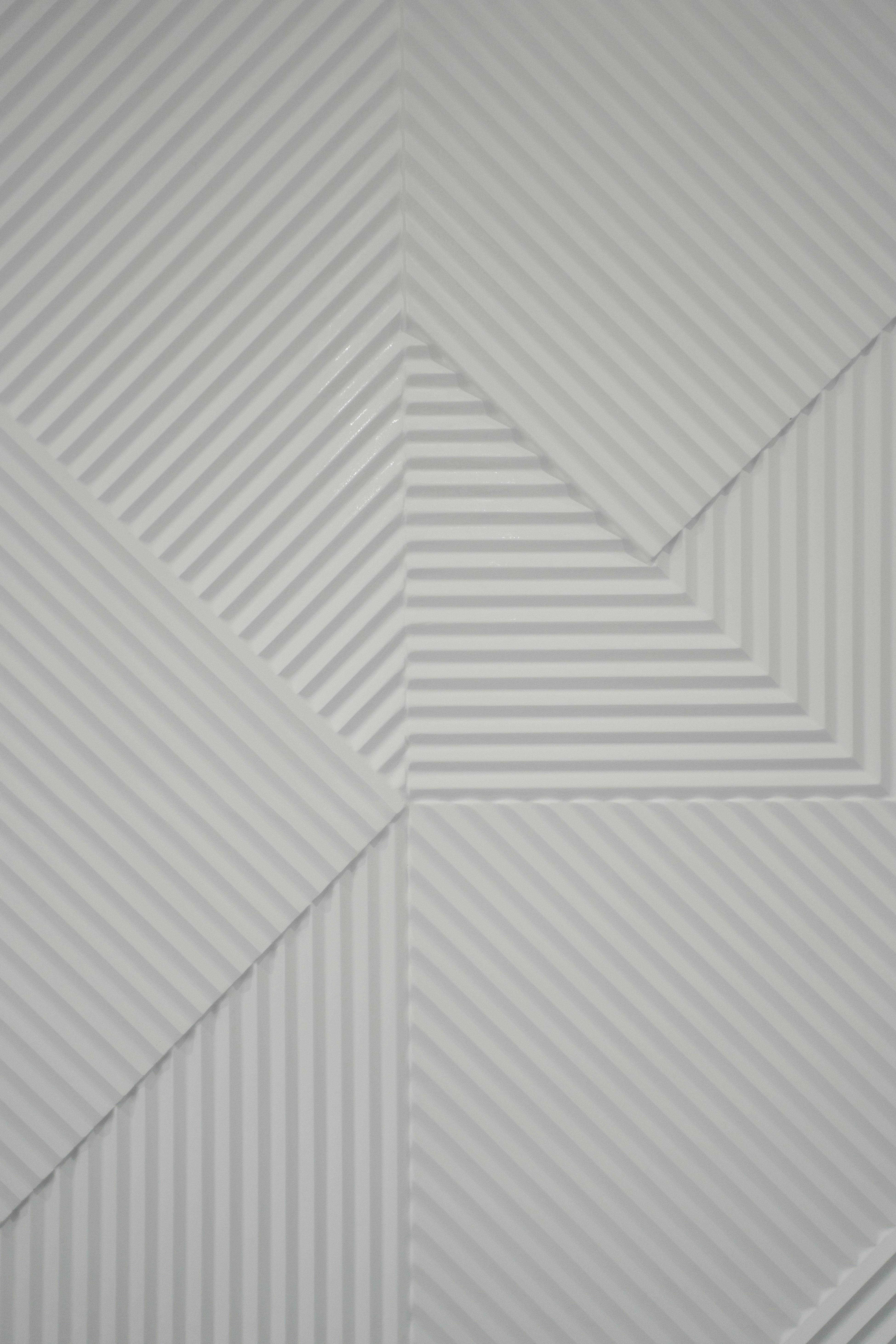 White geometric wall panels with intersecting lines